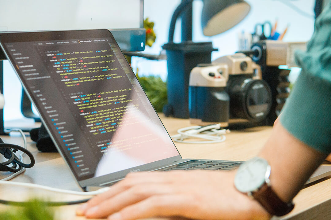 Web developer working on php code on a macbook pro